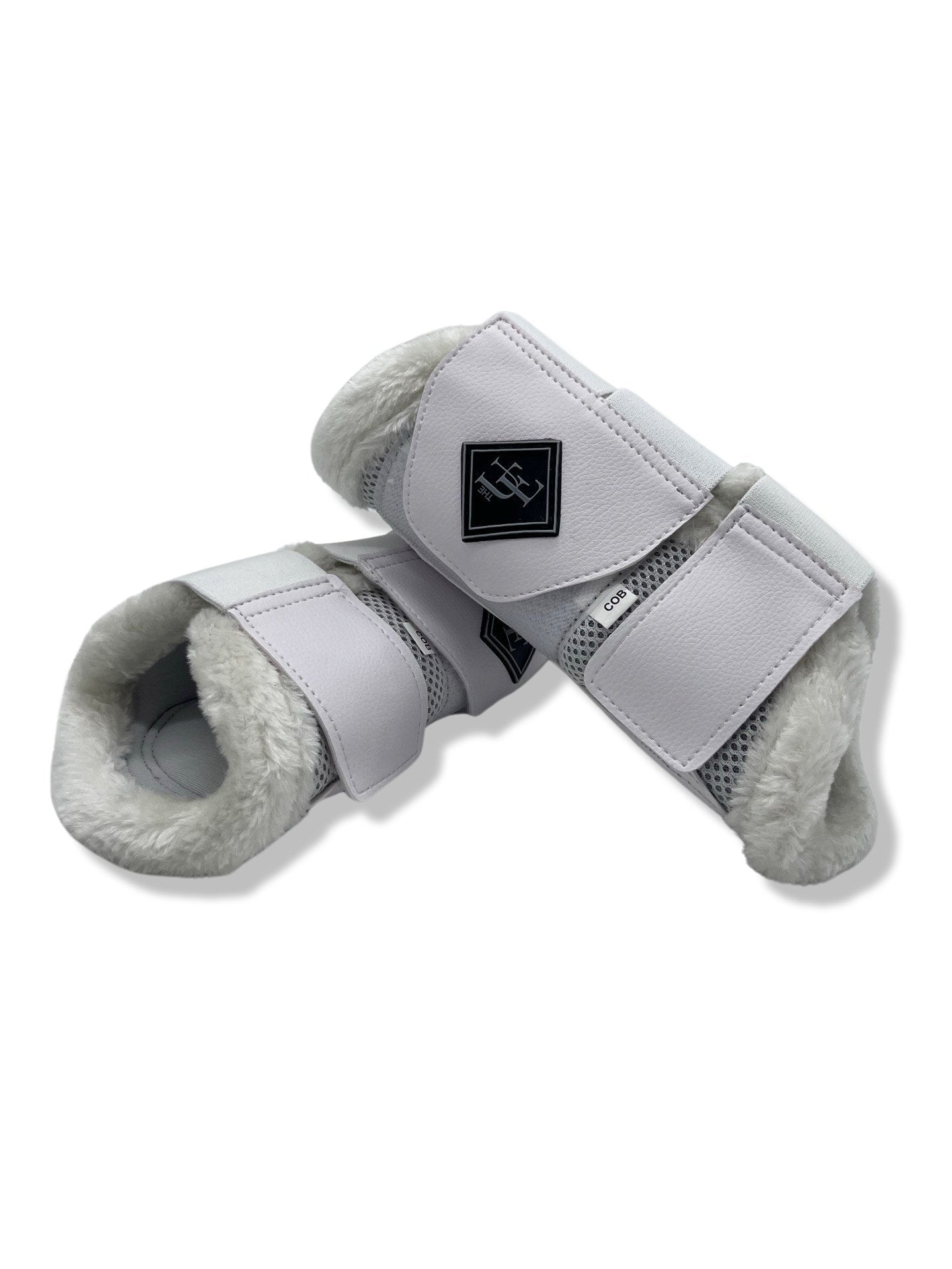 White Fleece Trimmed Brushing Boots, from The Urbany. Elevate your horse's style with sparkling crystals and comfort.