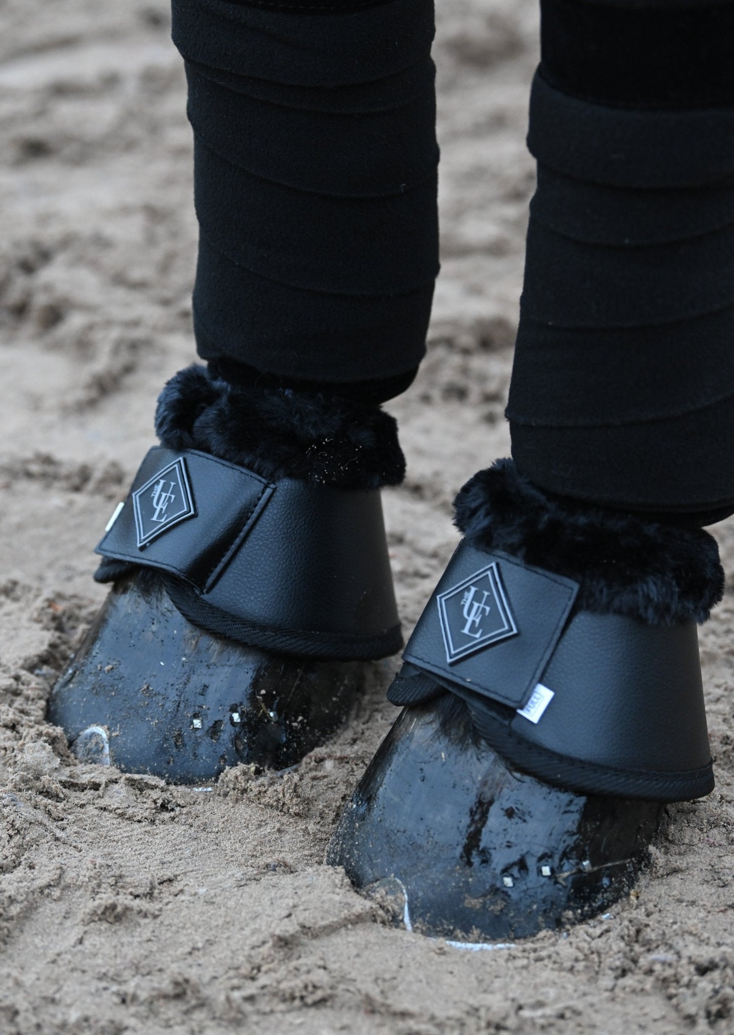 Black Fleece Trimmed Over Reach Boots, from The Urbany. Elevate your horse's style with sparkling crystals and comfort.