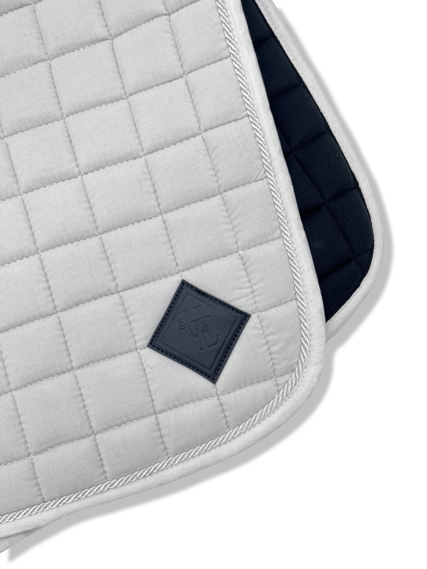 Pearly White Corduroy Dressage Saddle Pad, from The Urbany. Elevate your horse's style with sparkling crystals and comfort.