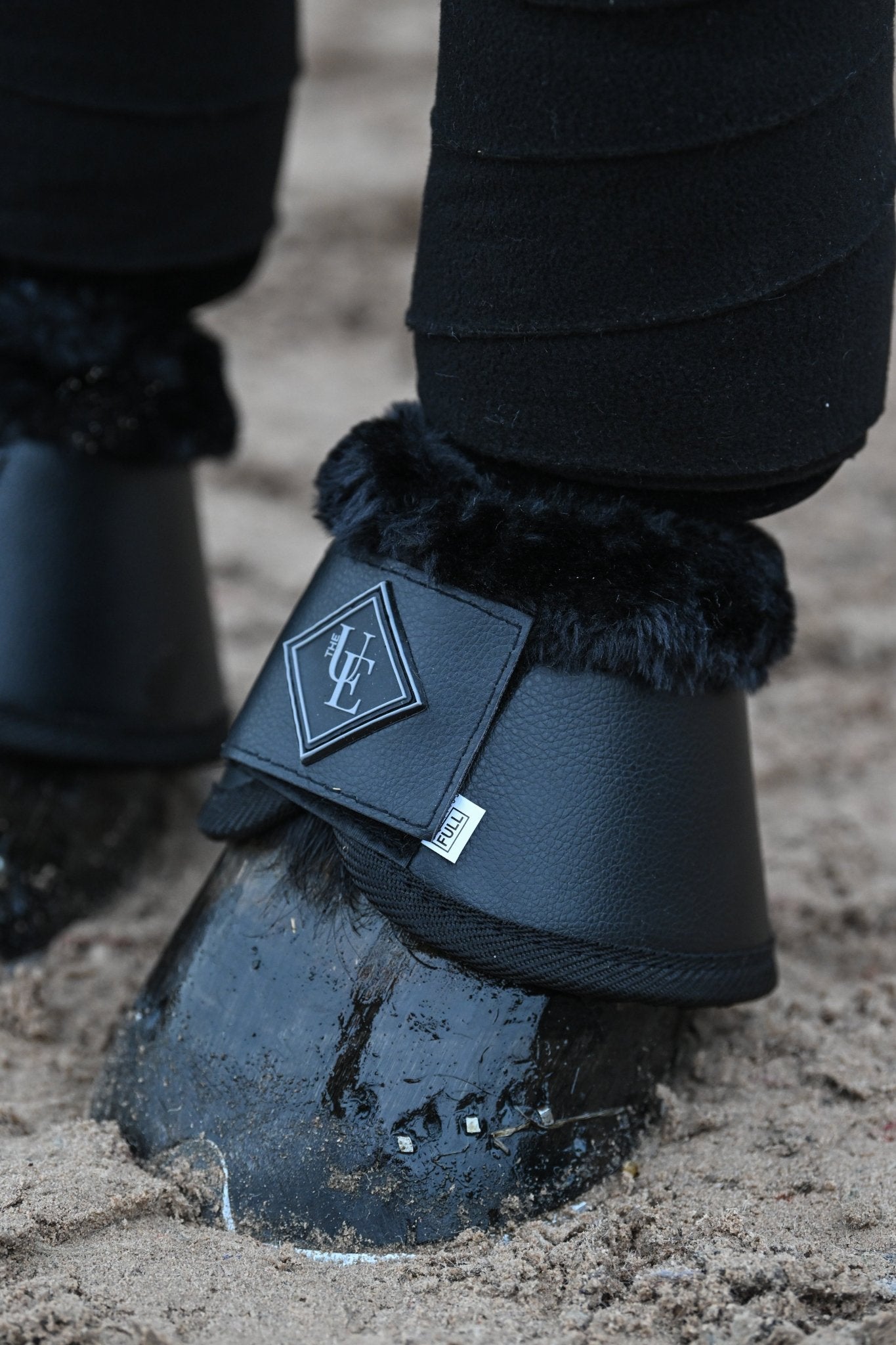 Black Fleece Trimmed Over Reach Boots, from The Urbany. Elevate your horse's style with sparkling crystals and comfort.